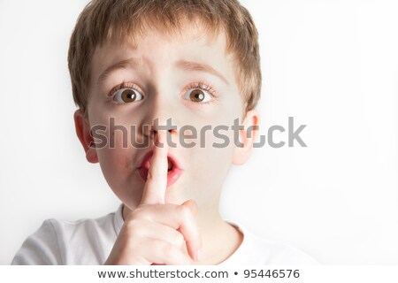 Zdjęcia stock: A Boy Is Telling A Secret With A Hand Symbol