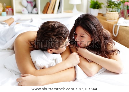 Stok fotoğraf: Young Attractive Happy Amorous Couple At Bedroom