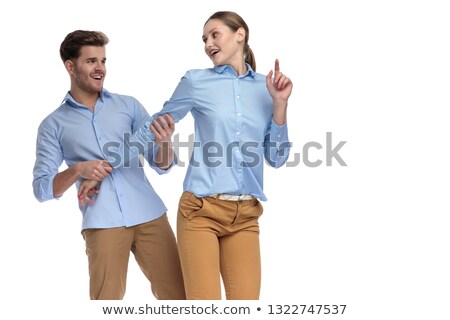 [[stock_photo]]: Happy Casual Man Pulling Back His Girlfriend By Her Arm