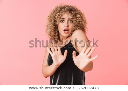Stock photo: Portrait Of Scared Curly Woman 20s Wearing Dress Expressing Frig