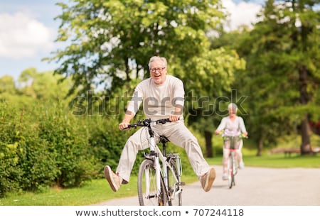 Stok fotoğraf: Elderly Couple Out For A Bike Ride