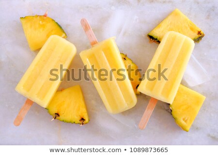 Zdjęcia stock: Yellow Icecream Lolly Pop Over Marble Light Background With Ice And Juice Flat Lay