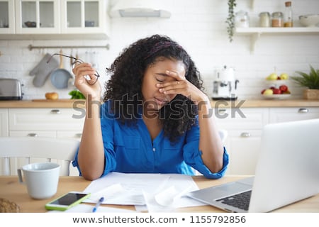 Stockfoto: Tired African Young Woman Sitting In The Kitchen