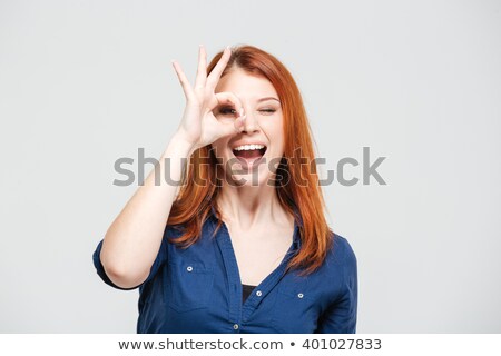 Foto stock: Woman Looking At Camera Through Her Fingers