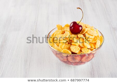 ストックフォト: Healthy Breakfast In Bowl With Golden Corn Flakes Ripe Slice Cherry On White Wood Board