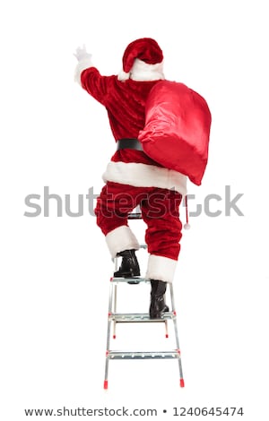 Foto stock: Back View Of Santa Stretching Hand While Climbing Ladder