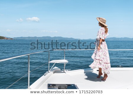 Foto stock: Side View Photo Of Young Amazing Woman On The Yacht