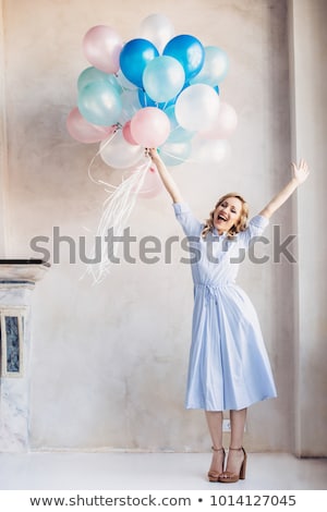 Stock photo: Blonde Happy Woman In Light Dress With Stay In Front Of Light Wall