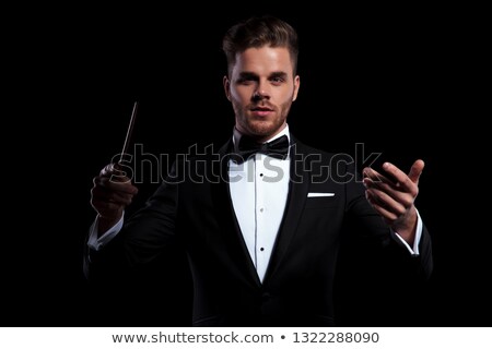 Foto d'archivio: Young Musician Conducting Using A Stick And Gesturing