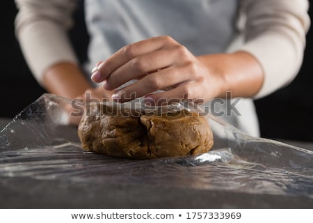 ストックフォト: Woman Wrapping Dough In A Plastic Wrap