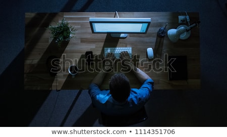 Stockfoto: Man With Headphones And Smartphone At Night Office