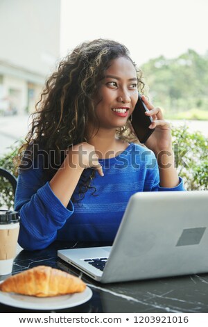 ストックフォト: Indonesian Businesswoman With Laptop And Hot Beverage Looking Away