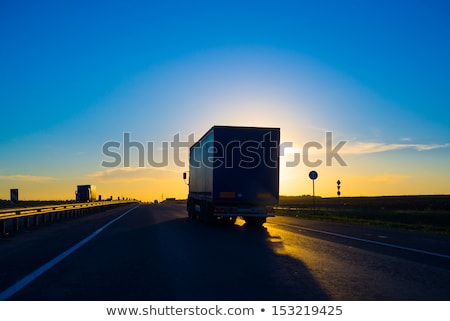 Silhouettes Of Truck On Horizon At Sunrise Foto stock © iunewind