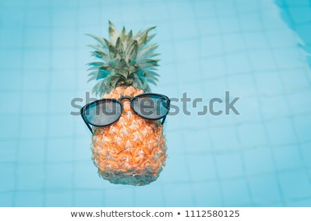 ストックフォト: Pineapple Wearing Sunglasses At Swimming Pool