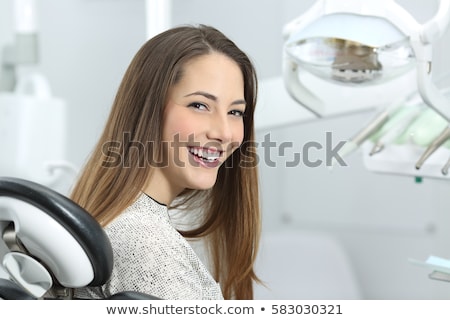 ストックフォト: Dentist Examining A Patients Teeth In The Dentists Chair