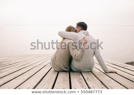 Stock fotó: Loving Couple Sitting On The Pier On Lake