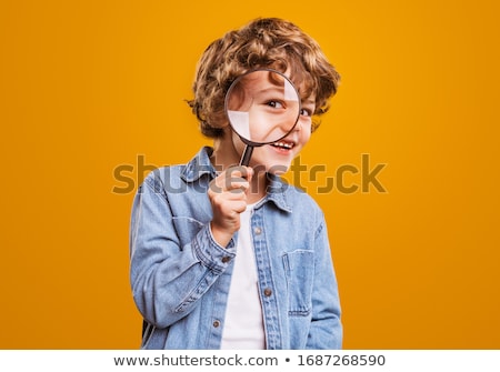 Stok fotoğraf: Boy Looking In A Magnifying Glass Against The Background Of The Garden Home Schooling