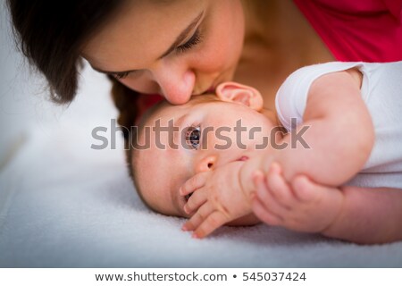 Mother Cuddling Her Daughter On Bed Foto d'archivio © Lighthunter