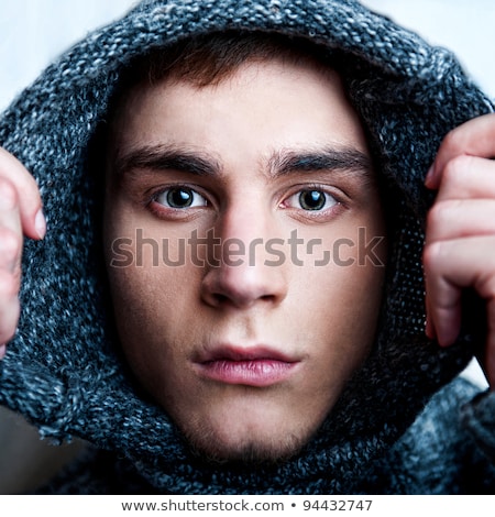 Stock photo: Portrait Of Young Handsome Man Putting On Warm Pullover And Look