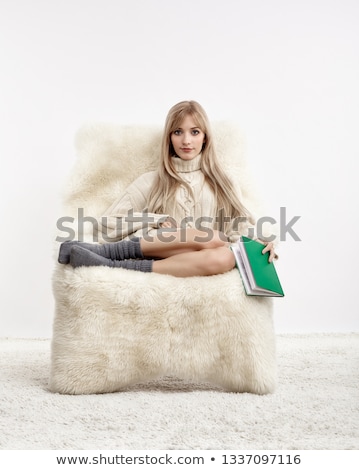 Foto d'archivio: Blonde On Furry Arm Chair