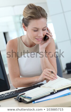 Foto stock: Pretty Blonde Businesswoman Consulting Her Agenda