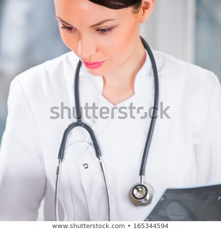 [[stock_photo]]: Portrait Of A Female Doctor Holding Ultrasound Results And Using