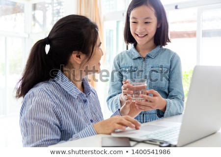 Foto stock: Business Woman Serving Glass Of Water At Office