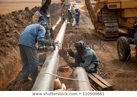 [[stock_photo]]: Male Welder Worker Wearing Protective Clothing Fixing Welding