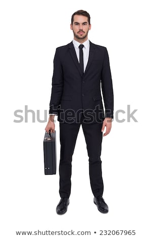 Stock fotó: Serious Businessman In Suit And Tie Holding A Briefcase