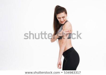 Zdjęcia stock: Fitness Woman In Pain Holding Her Arm And Looking Away