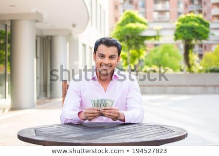 Stok fotoğraf: Man Holding Money And Money Tree In Background