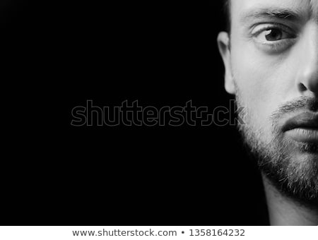 Foto d'archivio: Portrait Of Young Bearded Hipster Guy On Gray Dark Background Close Up Brutal Modern Man Lifestyle
