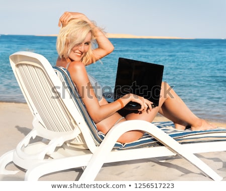 Foto stock: Business Woman Sitting In Chaise Lounge With Laptop