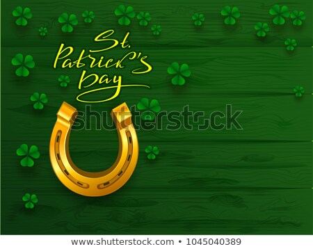 Stockfoto: St Patricks Day Text Greeting Card Golden Horseshoe And Green Leaf Clover Trefoil On Green Board