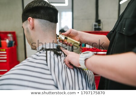 ストックフォト: Close Up Of The Hands Of A Skilled Barber Using A Brush