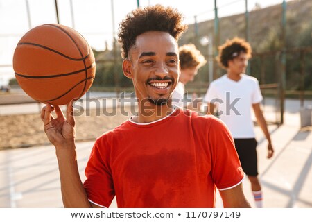 ストックフォト: Portrait Of Happy African Guy Spinning Ball On His Finger While