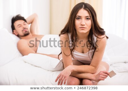 Сток-фото: Young Attractive Couple In Bed With A Condom