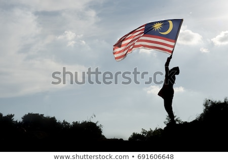 Stok fotoğraf: Boy Travels In Malaysia With Malaysia Flag Celebrating The Malay
