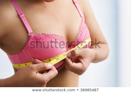 Foto stock: Woman Measuring Chest In Pink Bra