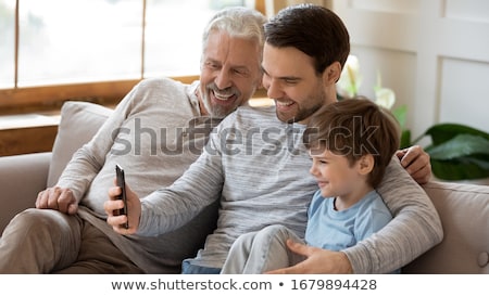 Foto stock: Middle Aged Man Sitting And Taking Selfie Pictures