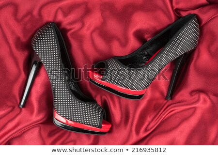 Stock fotó: High Heeled Shoes Lying On Black Fabric