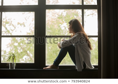 ストックフォト: Woman Looking Out Of Window