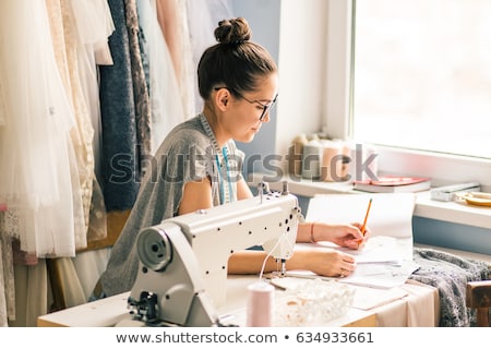 Сток-фото: Close Up Hands Woman Tailor Working Cutting A Roll Of Fabric On