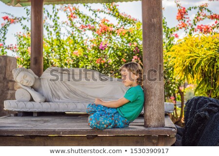 Stok fotoğraf: Cute Boy Listens To Music In A Buddhist Temple