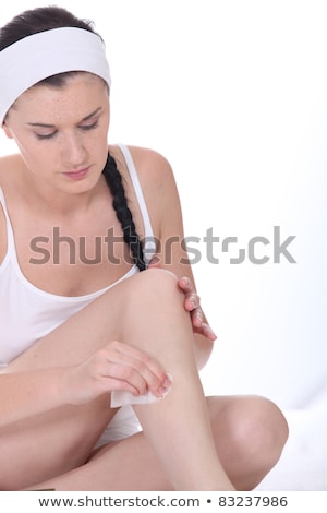 Foto stock: Woman Defuzzing Her Legs