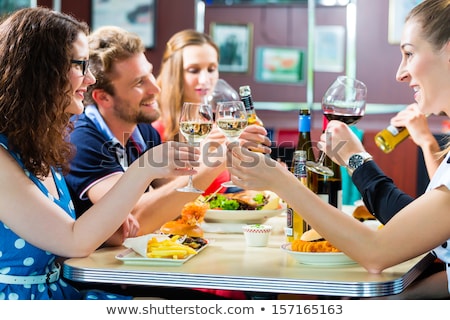People In American Diner Or Restaurant With Wine Stockfoto © Kzenon