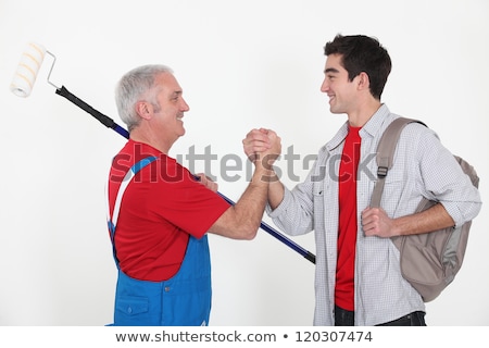 Foto d'archivio: Craftsman And Apprentice Shaking Hands