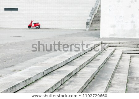 Stock fotó: Lonely Red Scooter Against White Wall In Urban Environment