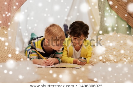 Foto stock: Boys With Magnifier And Map In Kids Tent At Home