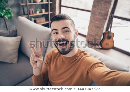 [[stock_photo]]: Close Up Of A Satisfied Young Man Dressed In Sweater